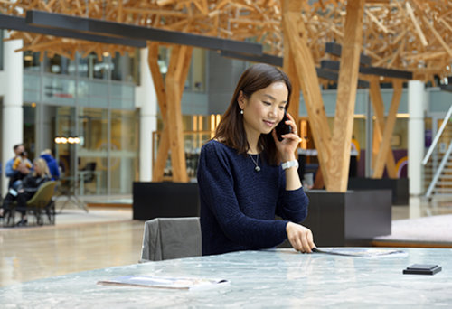 Business woman using her smartphone.