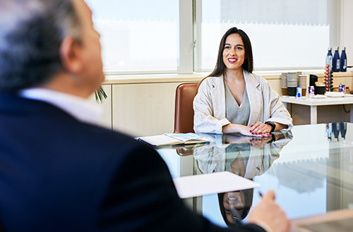 Business woman smiling in a meeting.