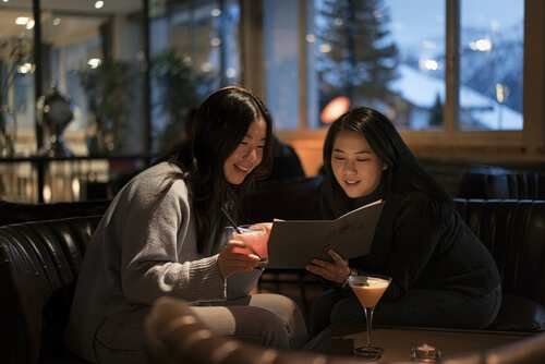 Two girls reading a book